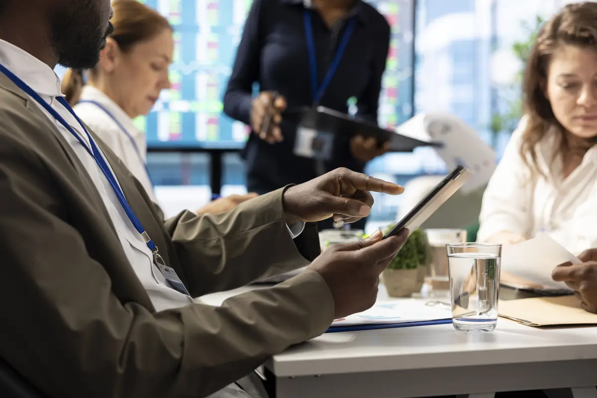 Shareholder examining infographics and resource allocation on tablet