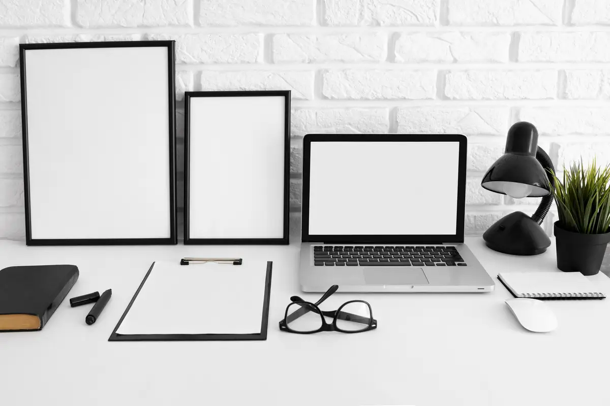 Front view of desk with laptop and glasses