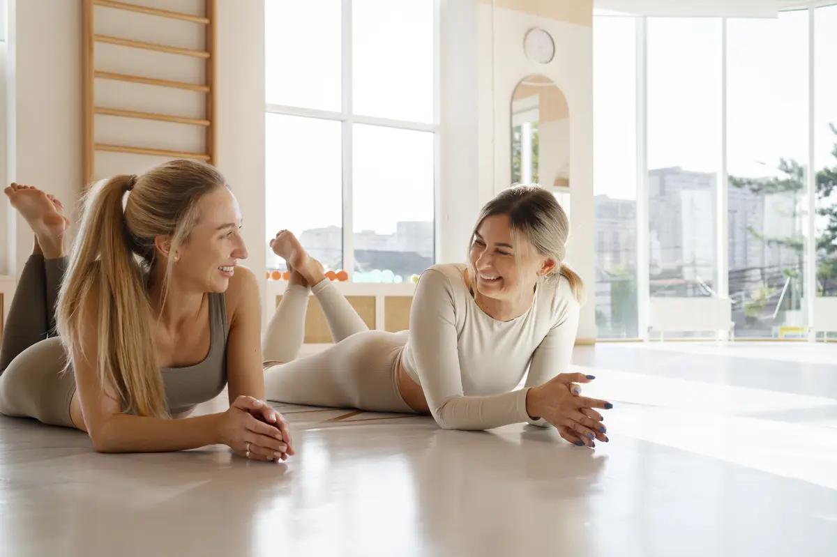Full shot women doing pilates together