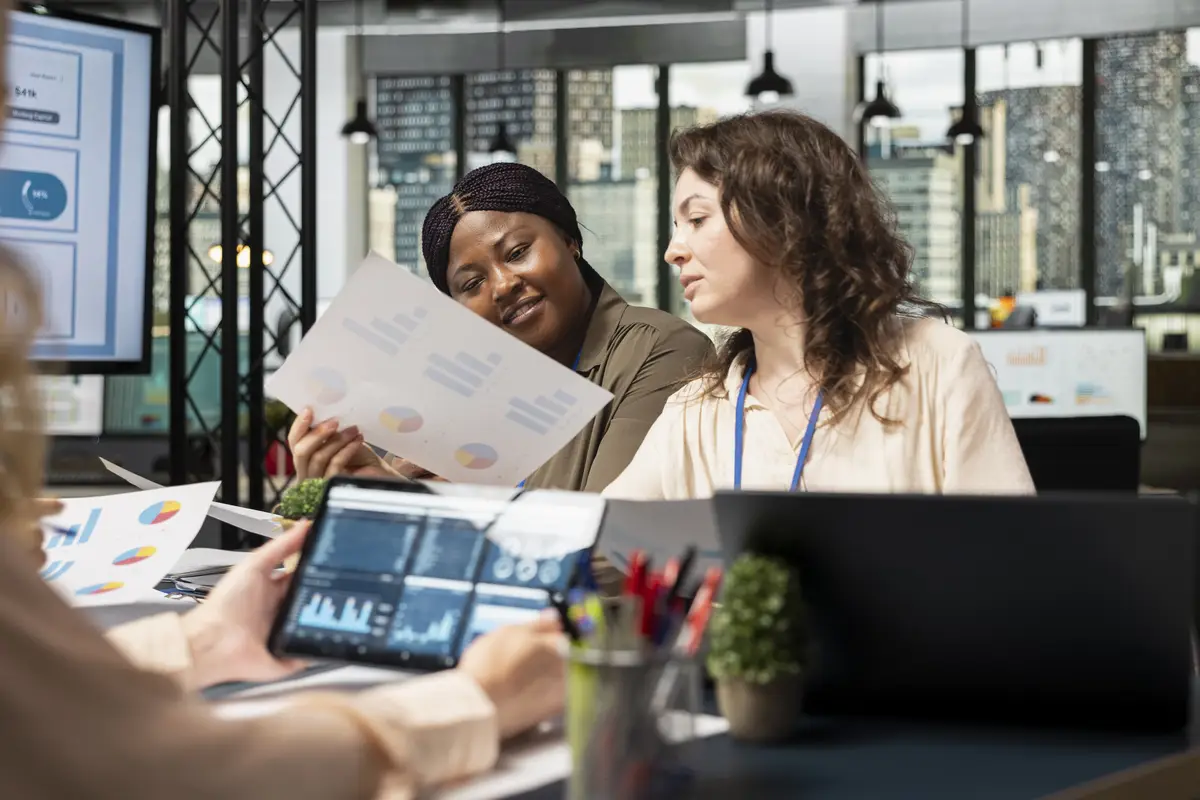 Group of business associates meeting in boardroom to align performance goals with project indicators