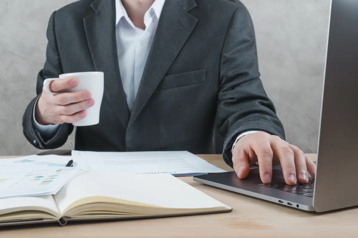 Office desktop with laptop and a notebook