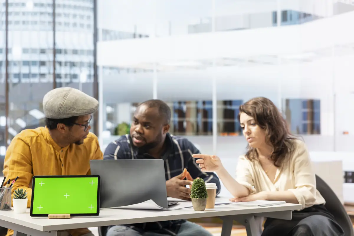 Business partners negotiating with woman realtor next to mockup
