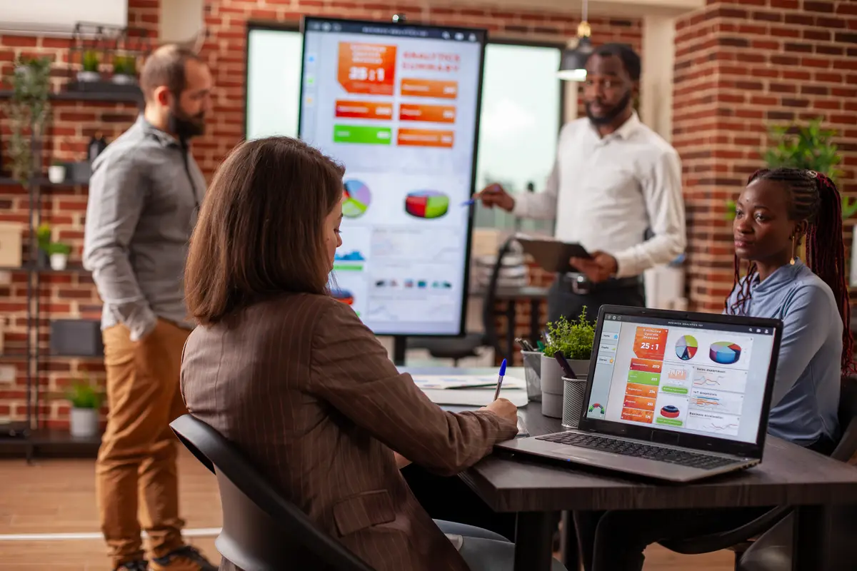 Manager taking notes at team meeting
