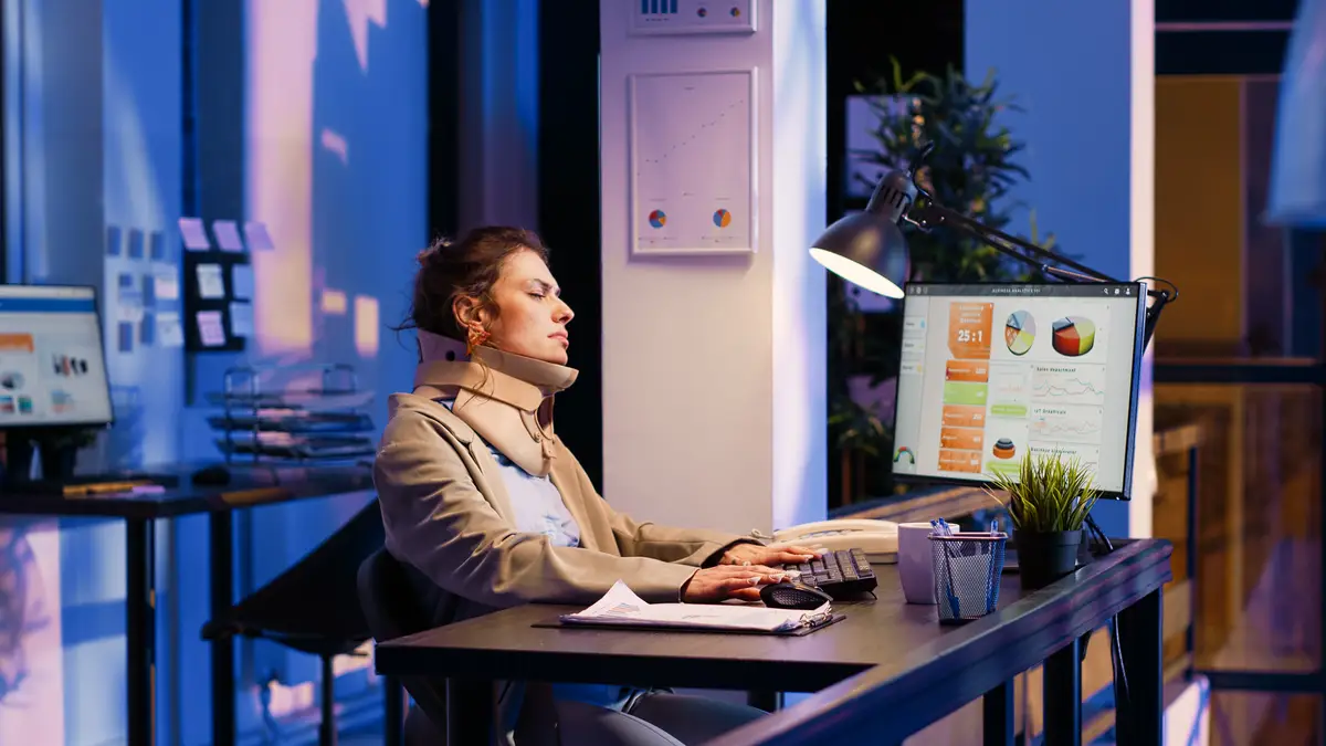 Businesswoman wearing cervical neck collar in office