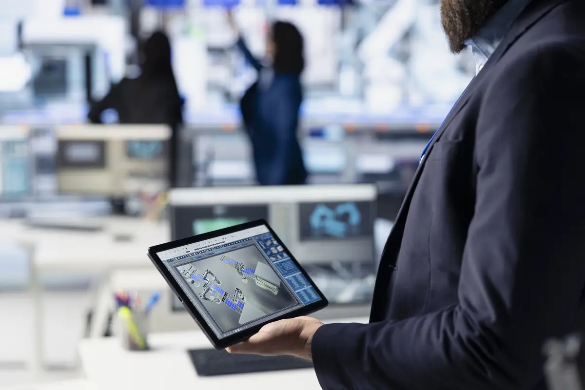 Photovoltaics factory technician creating CAD solar modules models using tablet