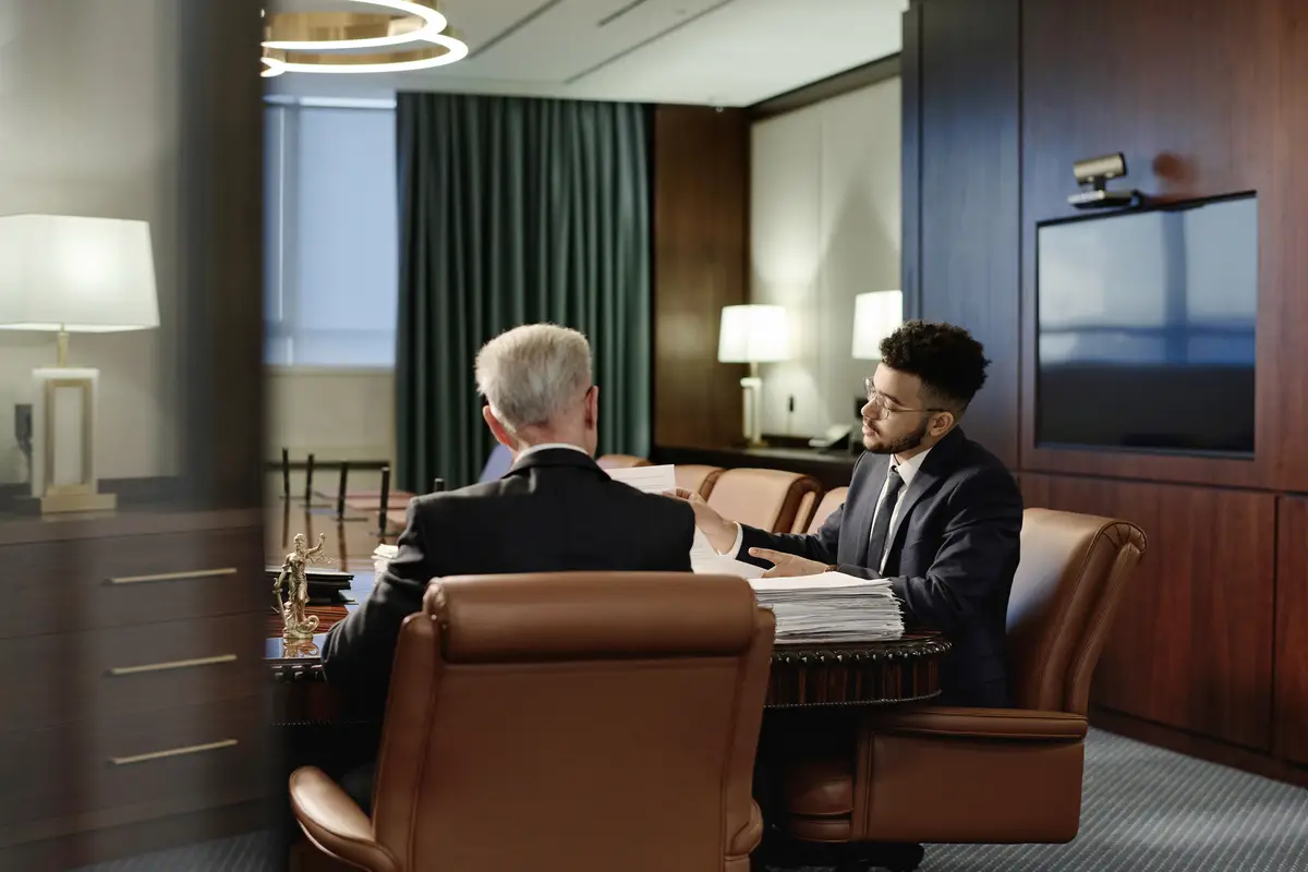 Biracial Jurists Doing Paperwork in Team Sitting in Office