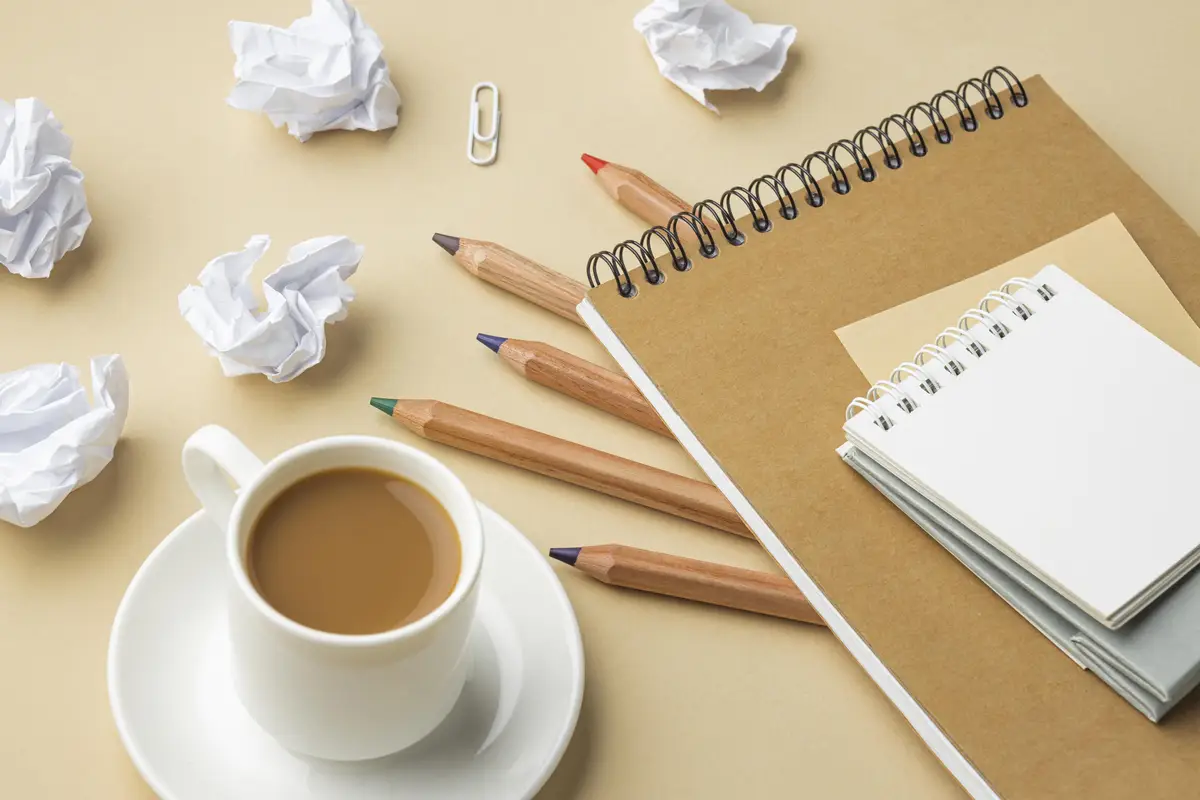 High angle of notebook for house renovation with colored pencils