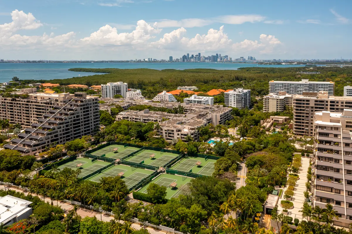 Aerial drone photoshoot in commercial areatropical vegetation around blue sky and water canal