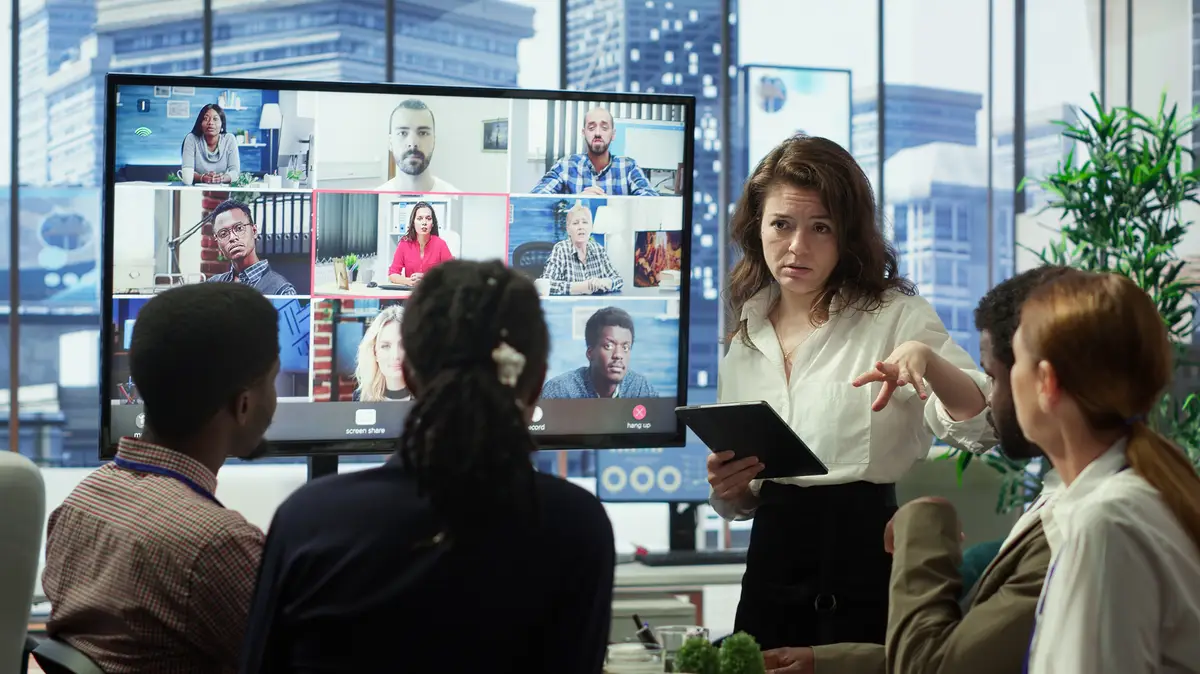 Business team in a boardroom attend videocall meeting with investors group discussing about