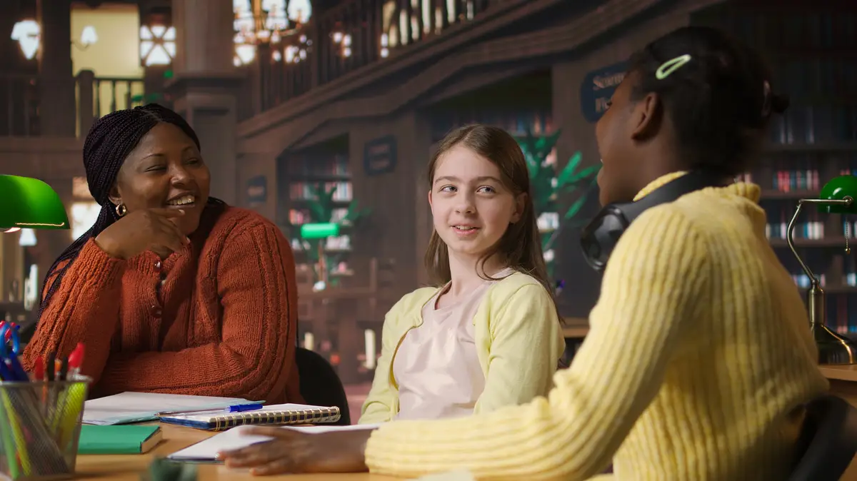 African american private tutor offering support to diverse schoolgirls