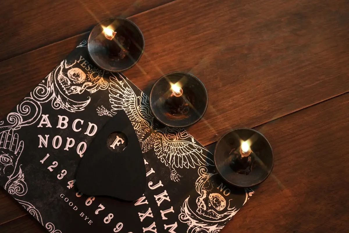 Ouija board and candles arrangement top view