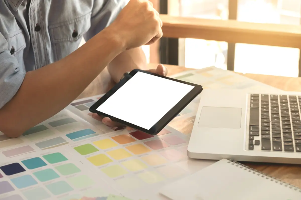 Midsection of businessman using digital tablet on table in office