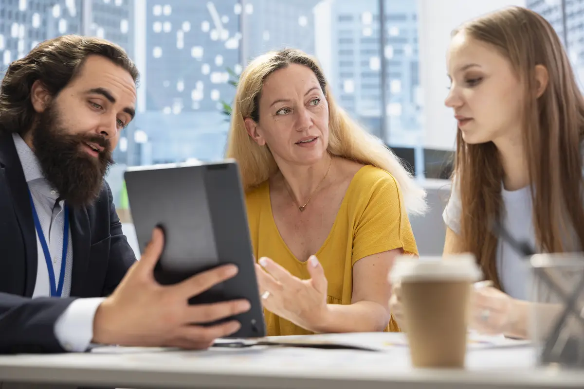 Consultant utilizing financial planning software on tablet to help family