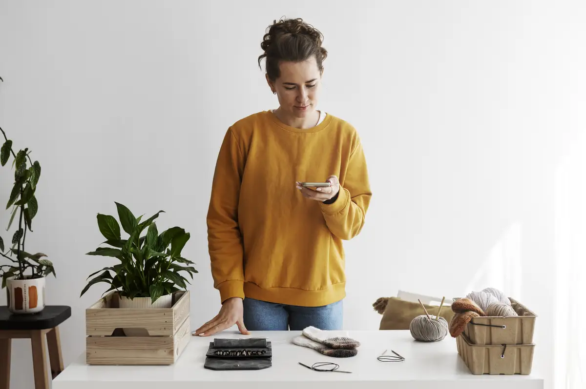 Young adult organizing their knitting products
