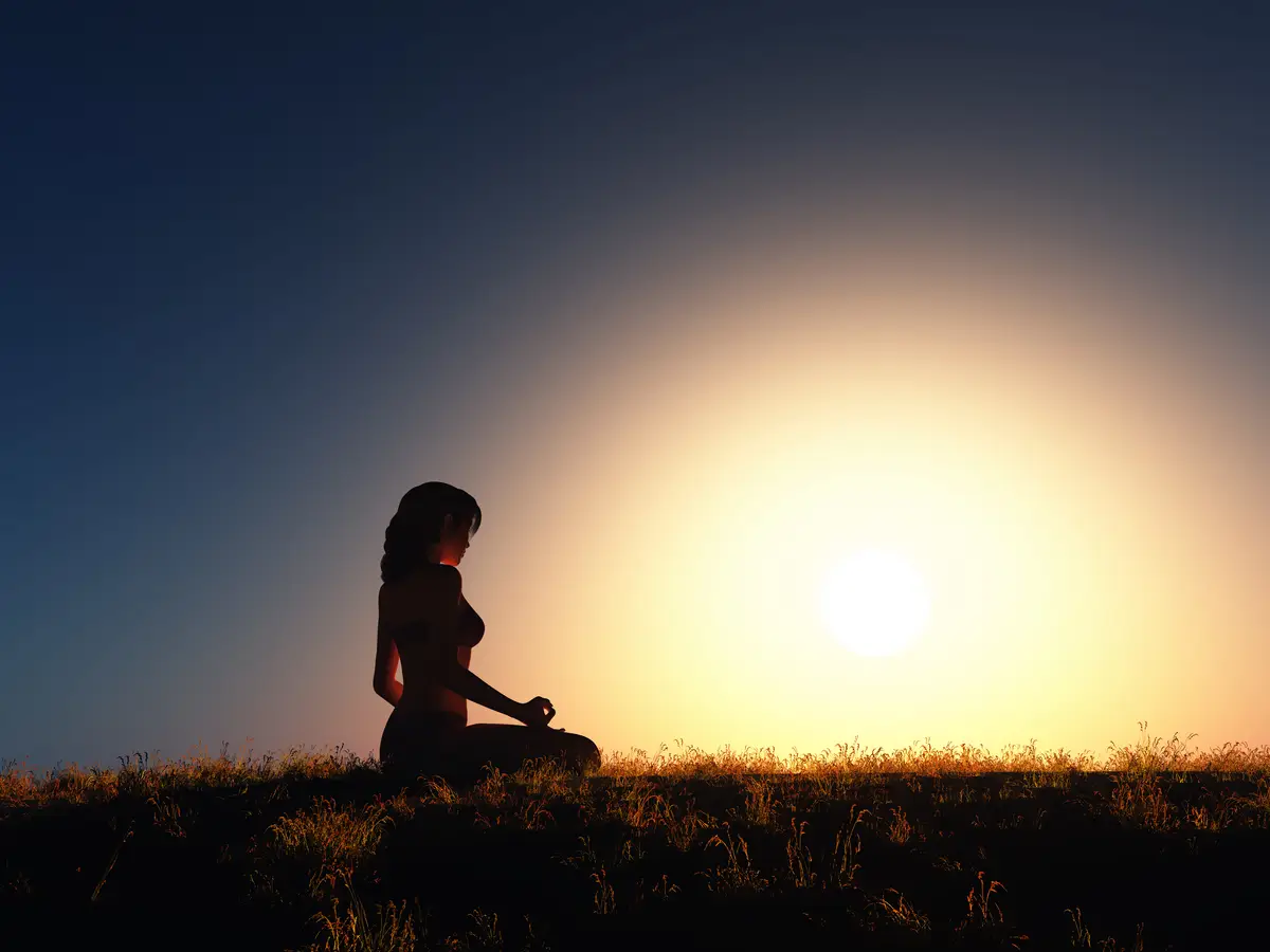 3D female in yoga position against sunset sky