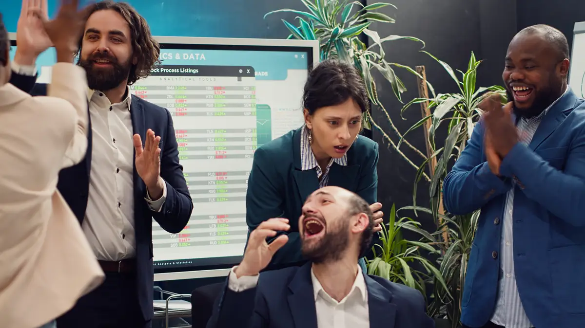 Joyful proud employees celebrating their business success finding out results