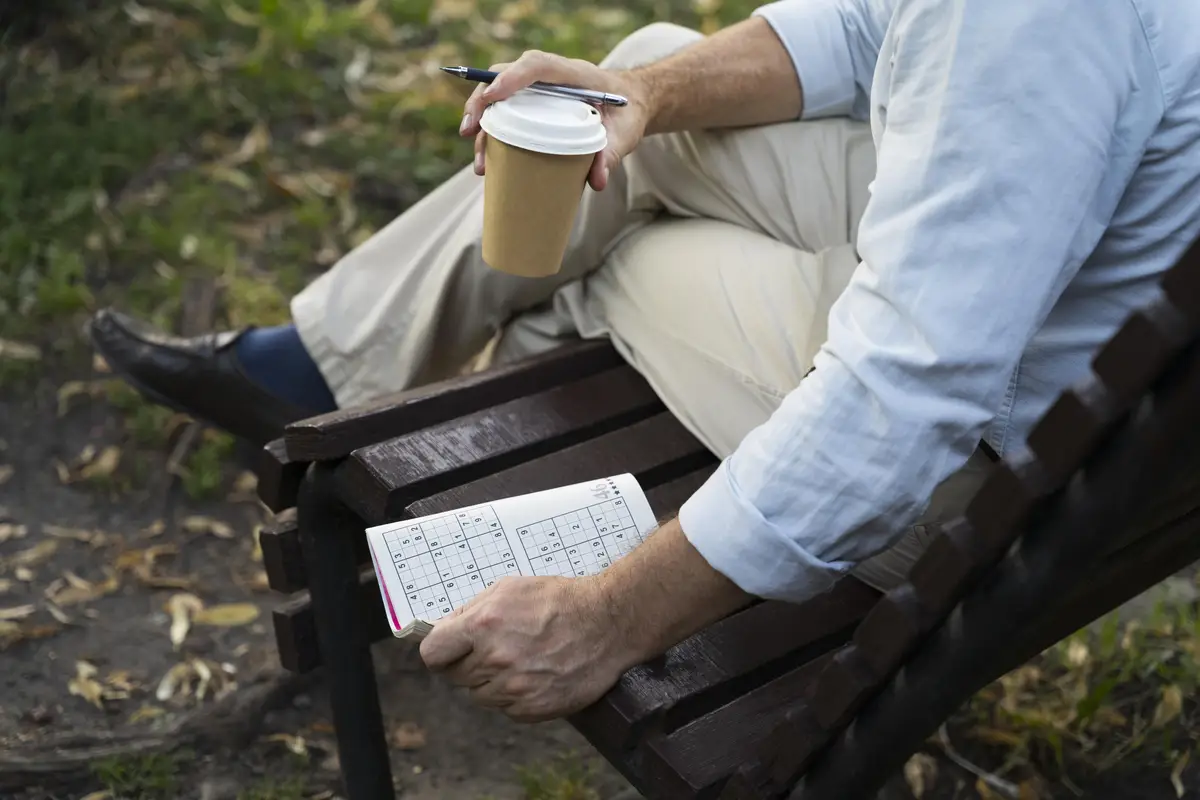 Man enjoying a sudoku game on paper by himself
