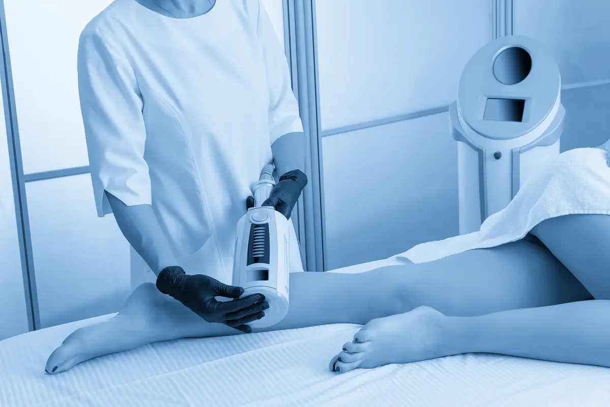 Midsection of woman with iv drip on bed at home