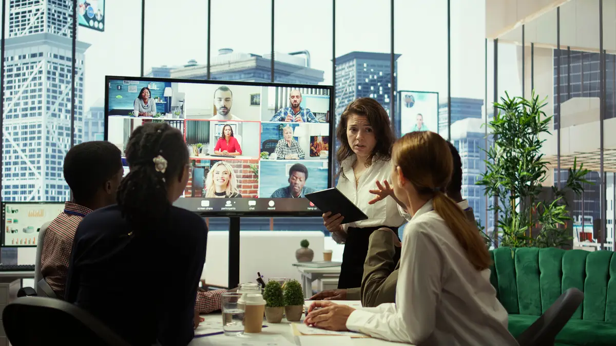 Business team in a boardroom attend videocall meeting with investors group