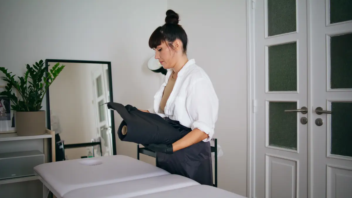 Professional tattooist putting diaper on couch place tattoo master working home