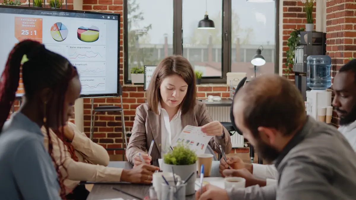 Diverse group of workmates discussing business strategy in startup office. Colleagues working on project planning and presentation for company development and growth. Brainstorming ideas