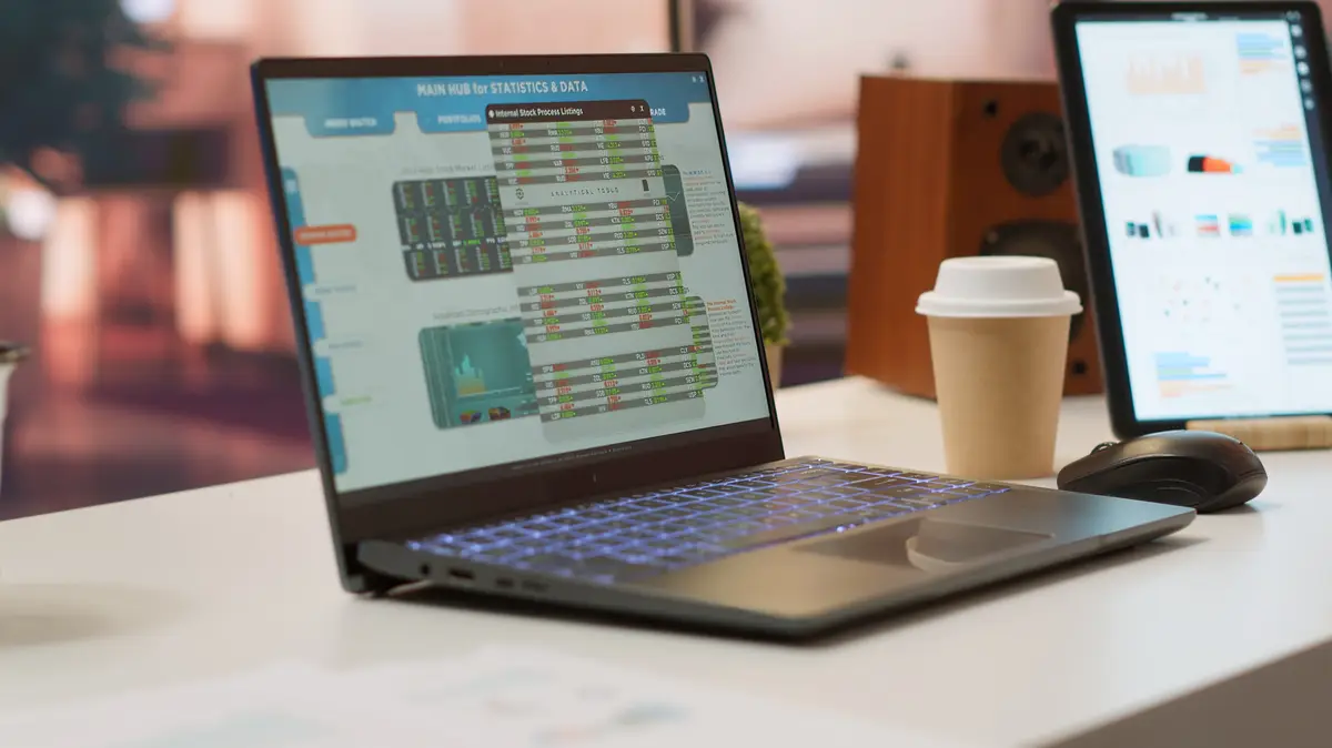 Empty home office with tablet and laptop shows infographics and accounting data