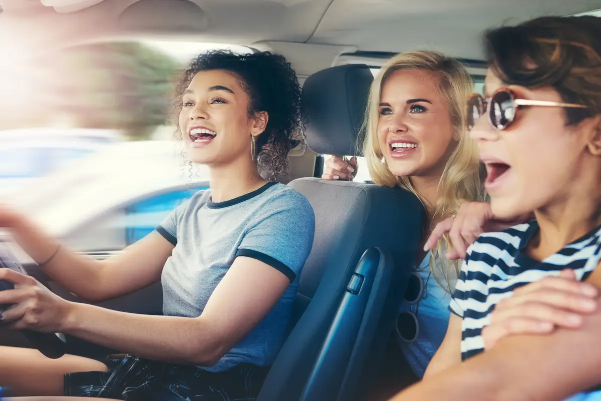 Friends women and excited with driving car on speed for fun on roadtrip travel and holiday in Spain People vehicle and happy or smile for transportation with laughing for vacation and adventure