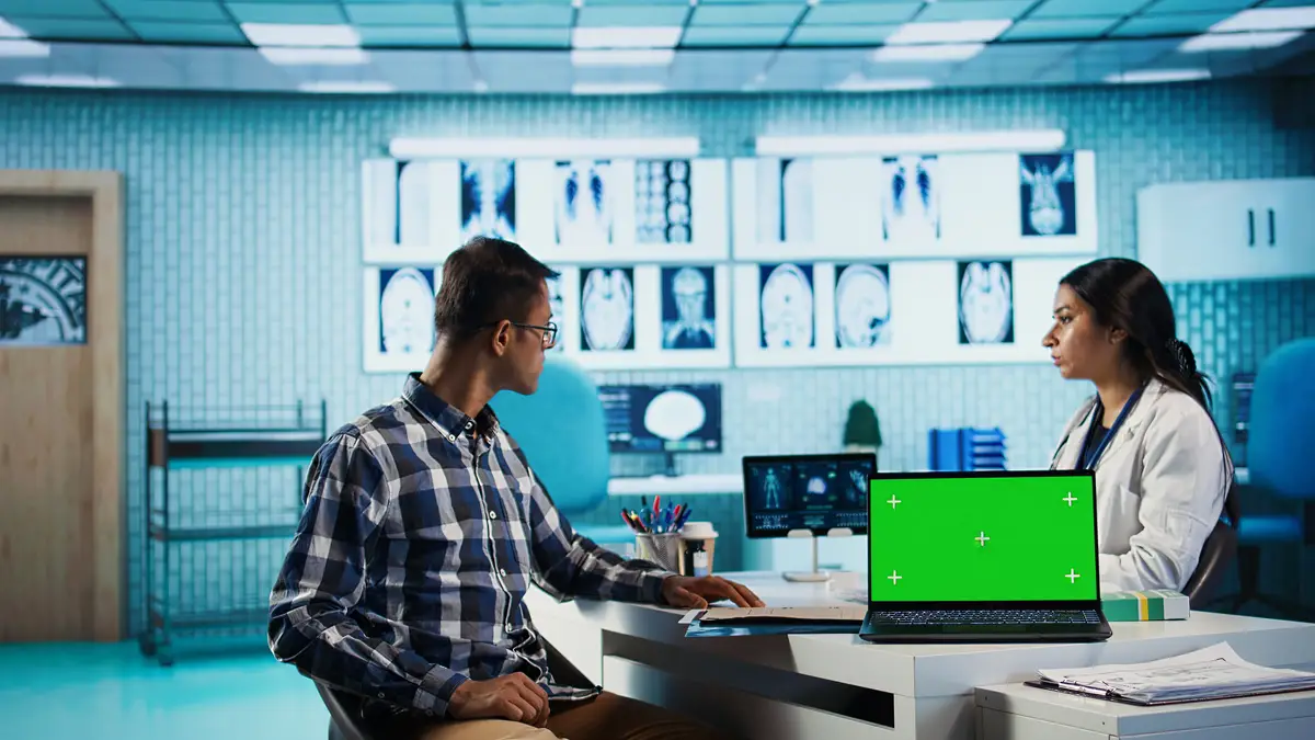 Indian medic consulting her patient in medical facility next to copy space