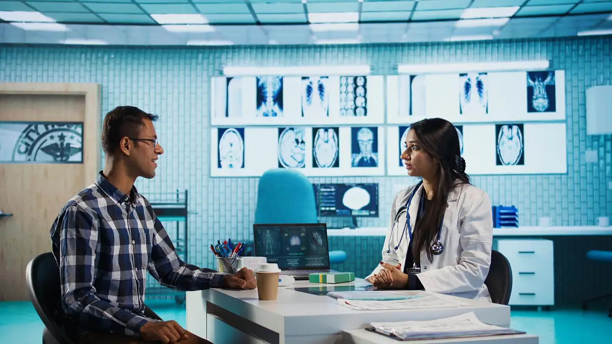 Specialist and patient discussing diagnostic results in a modern medical office