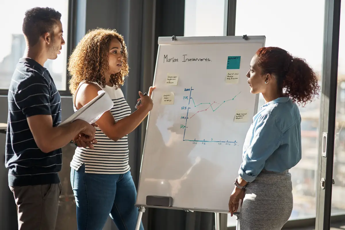 Teamwork group and collaboration with notes on whiteboard for brainstorming on project or deadline Coworkers people and planning for ideas process or presentation in business meeting for workshop