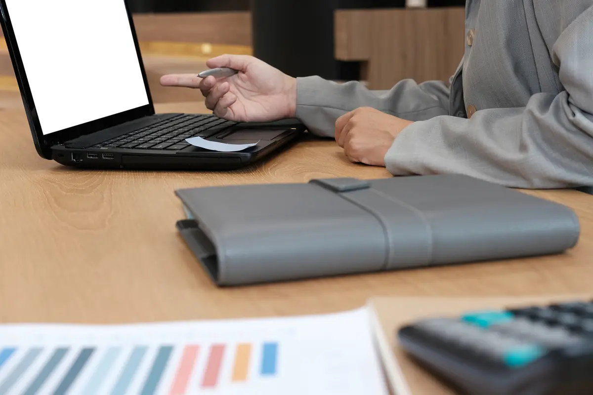 Midsection of man using laptop on table
