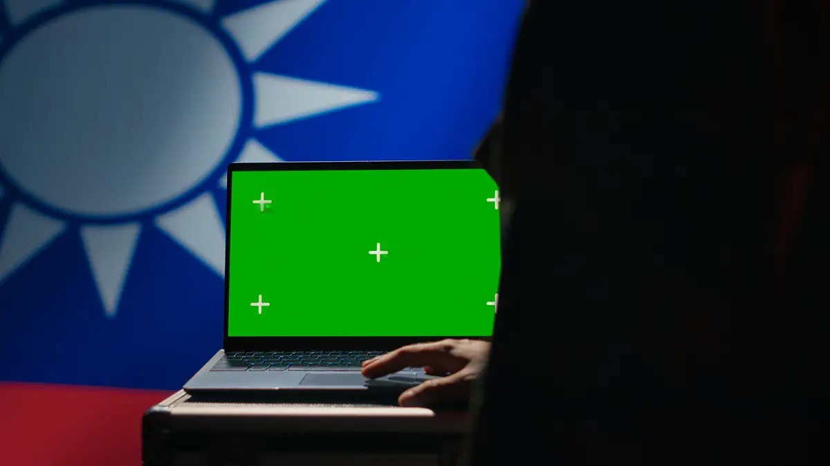 Taiwanese insurgent using military tech on green screen laptop