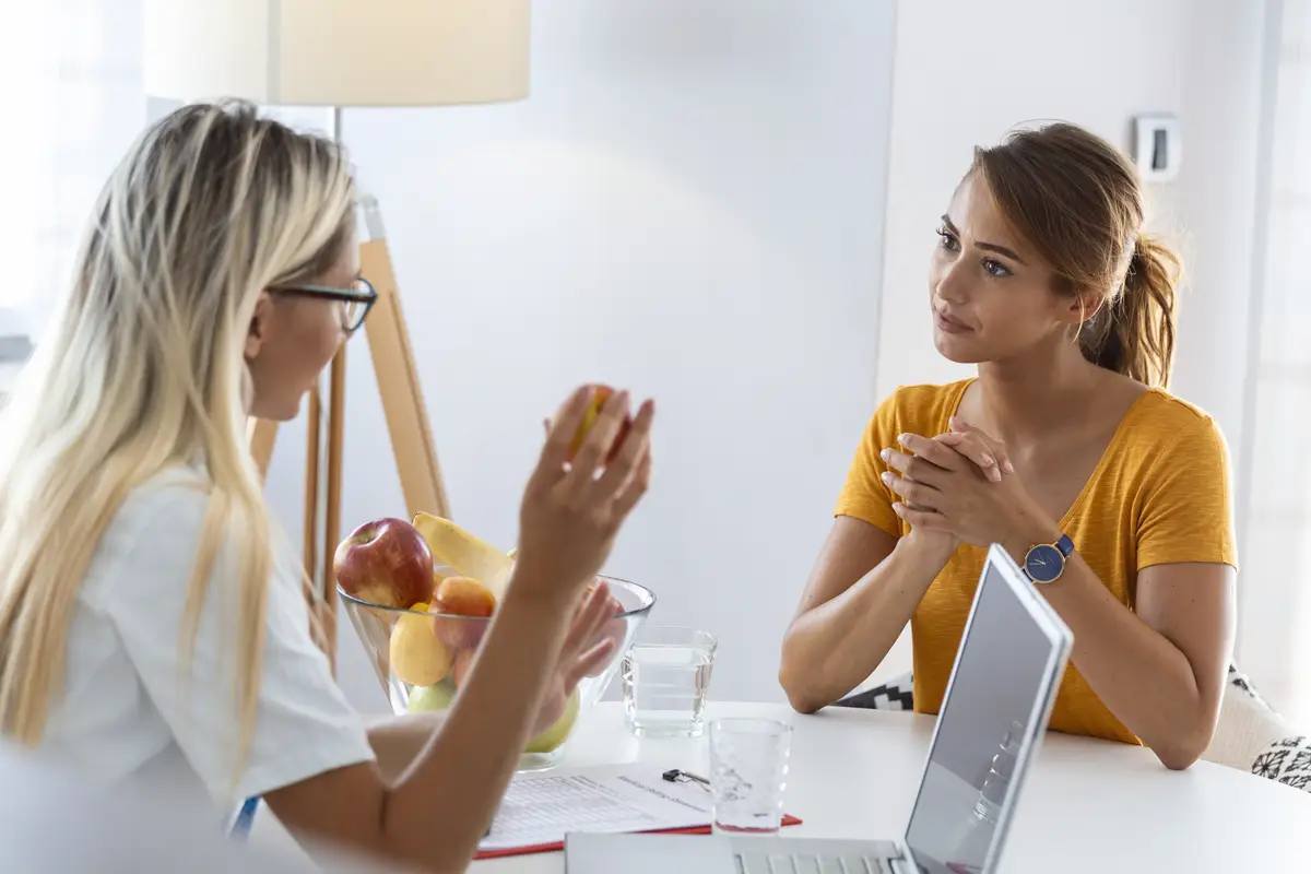 Female nutritionist giving consultation to patient Making diet plan in weight loss clinic