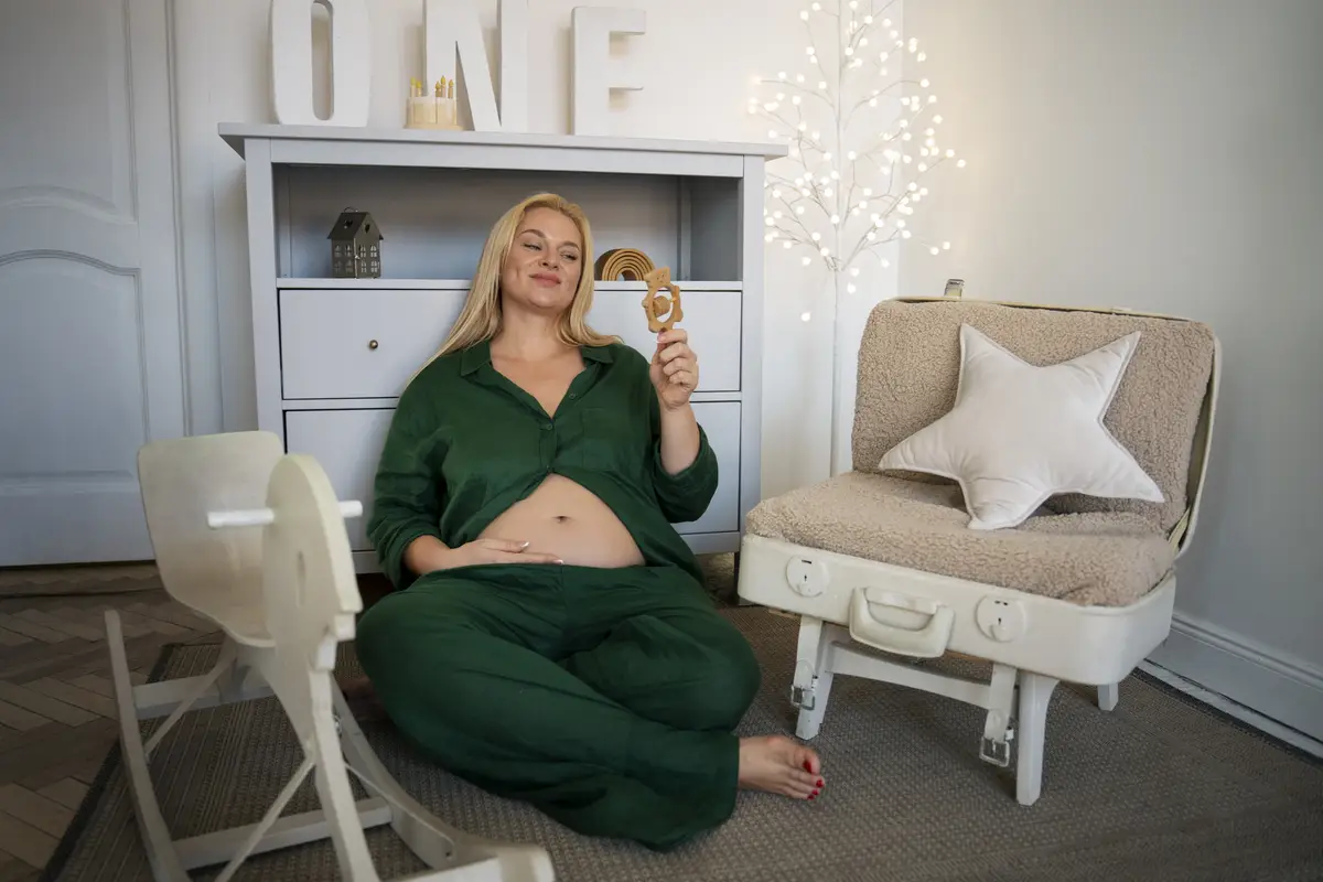 Full shot pregnant woman spending time indoors