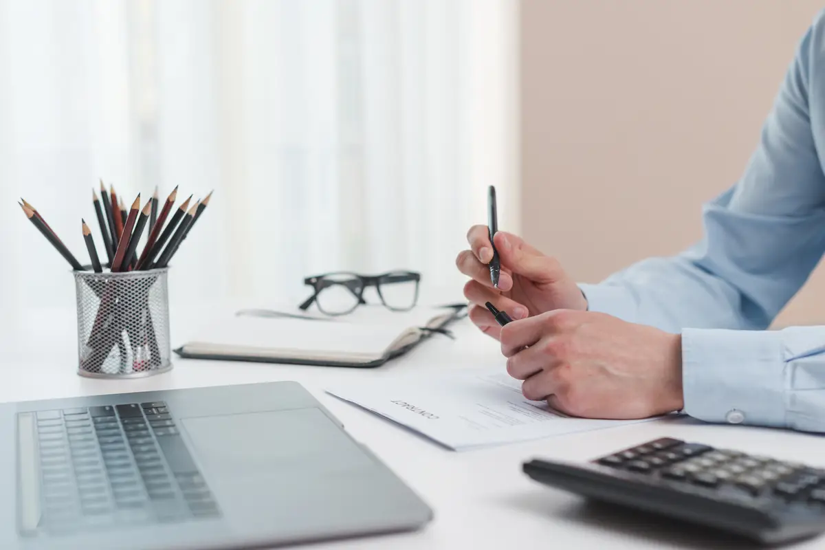 Office desktop with laptop and a calculator