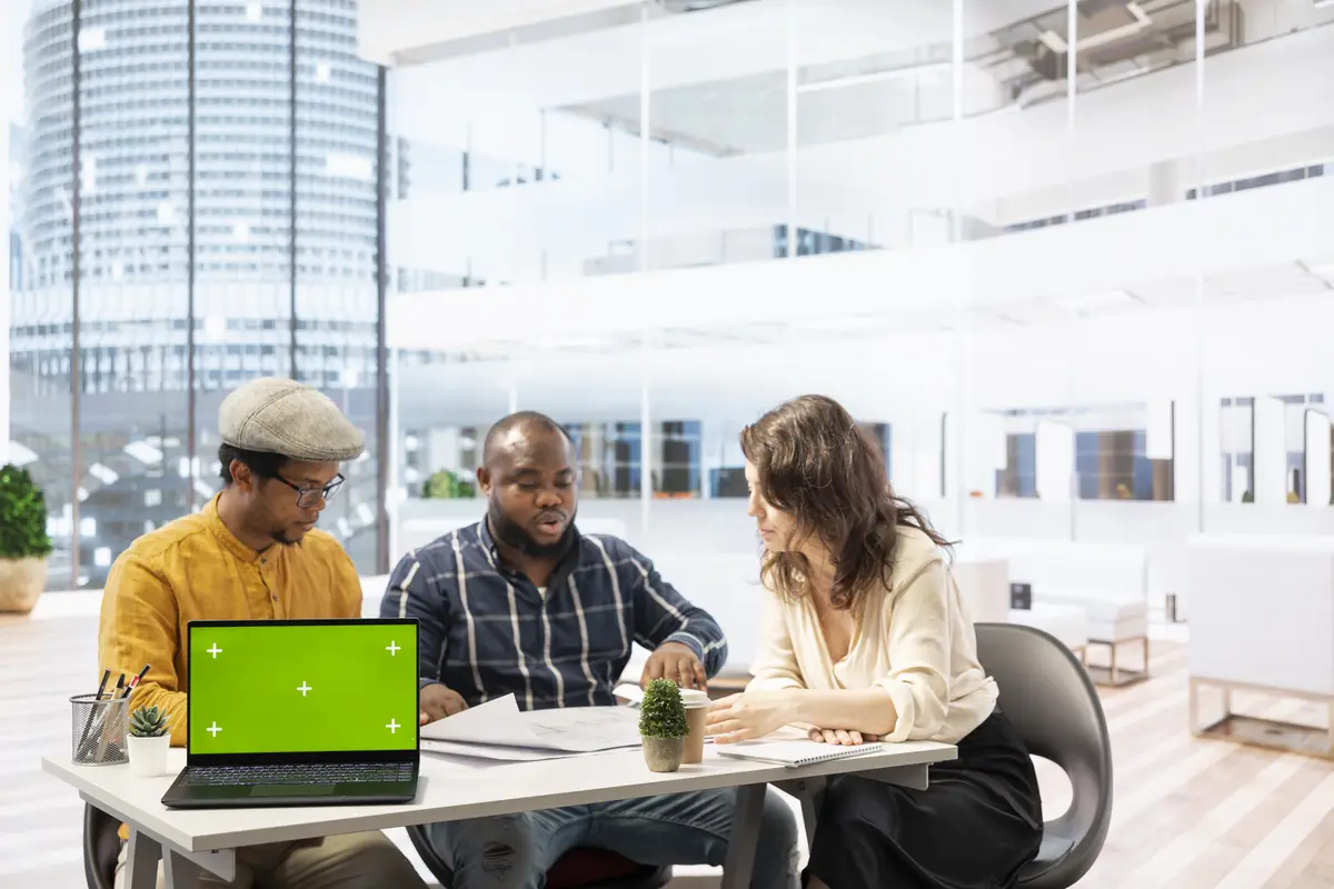 Businessman discussing with the real estate agents next to chroma key