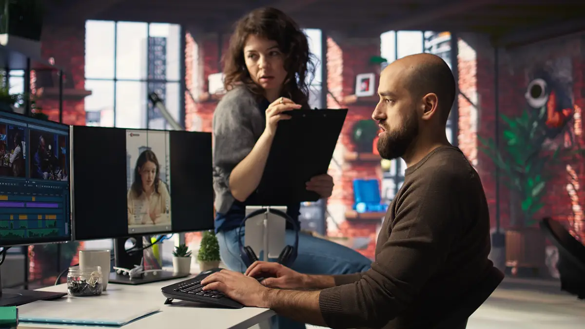 Team discusses content strategy and trends while reviewing footage on computers