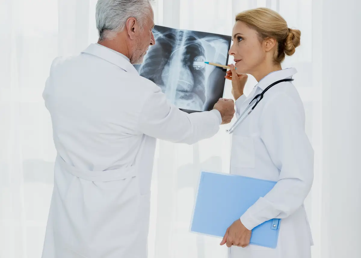 Doctor pointing at pacemaker on x-ray