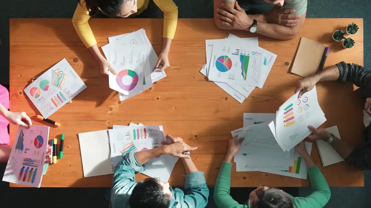 Top view of start up business team holding paper while discuss idea Symposium
