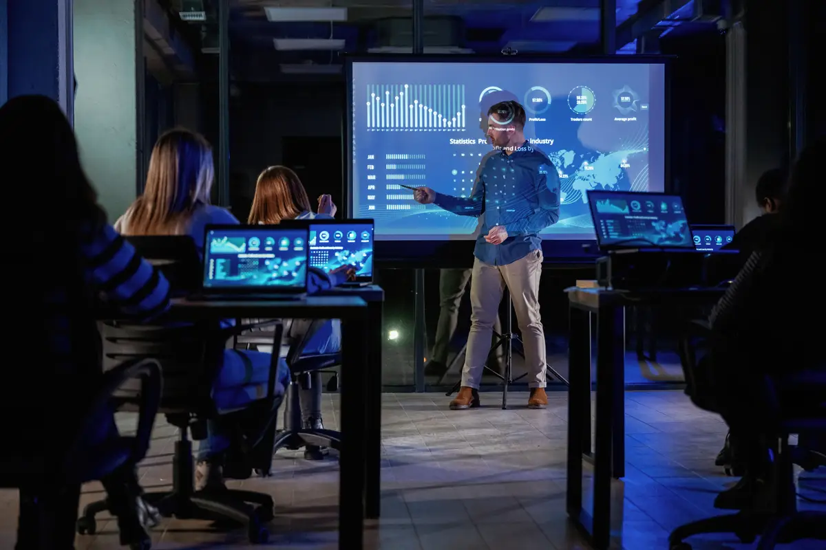 Smart coach Male business trainer is against projector with data teaching people