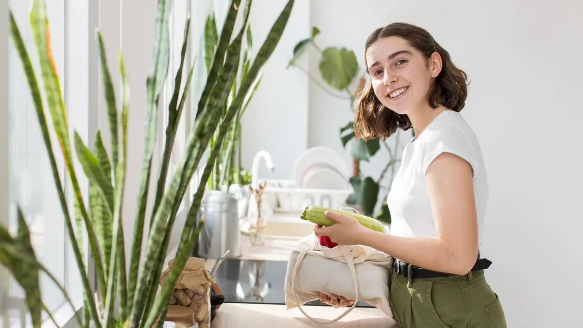 Smiley woman holding organic vegetables