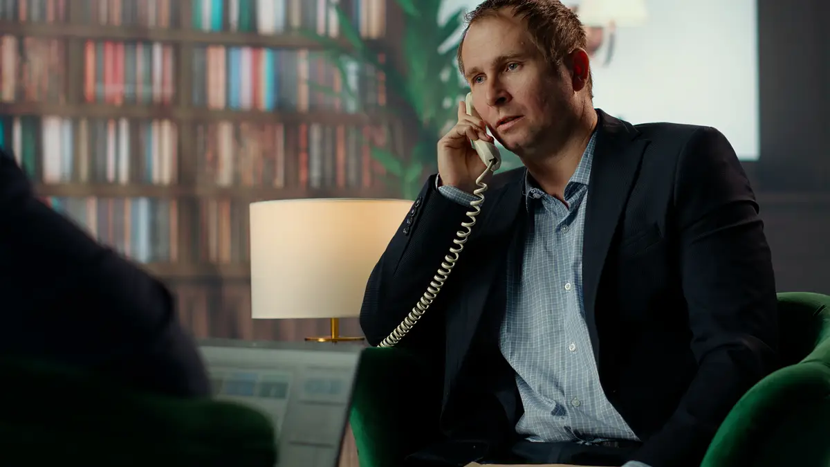 Intelligence officer on a secure line answering phone call in CIA safe house