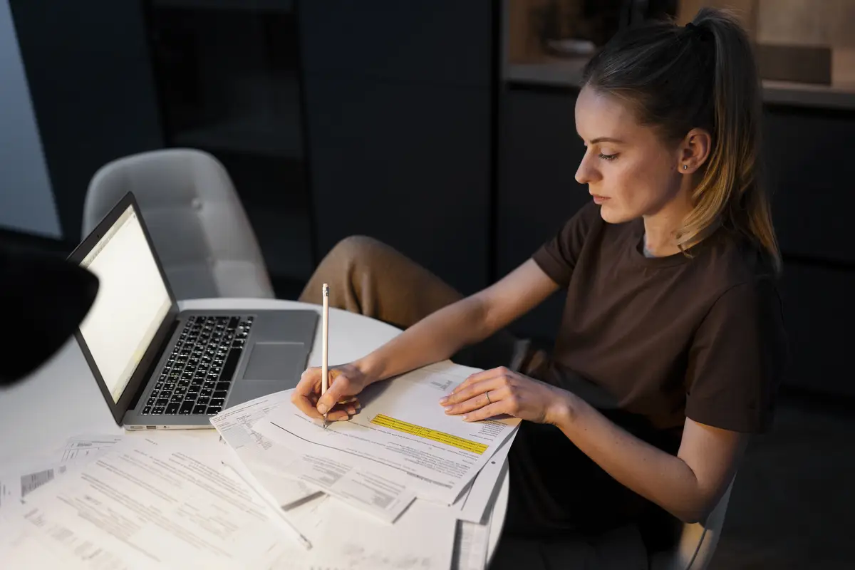 Medium shot woman working on laptop