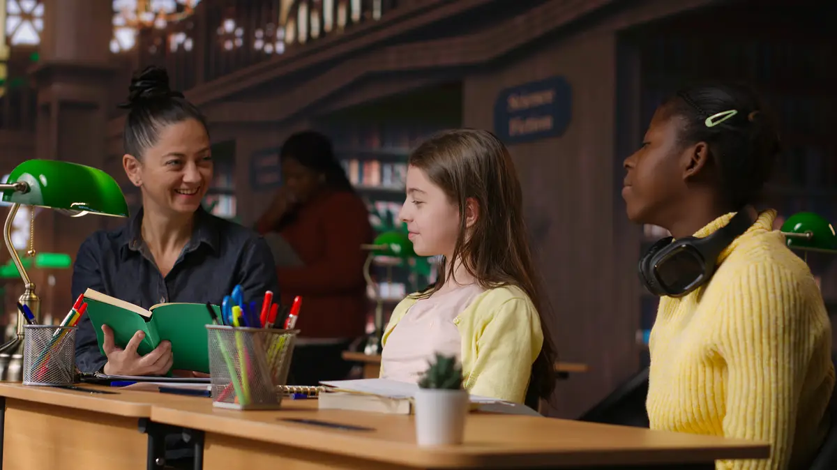 Elementary students receiving support from a tutor working on homework