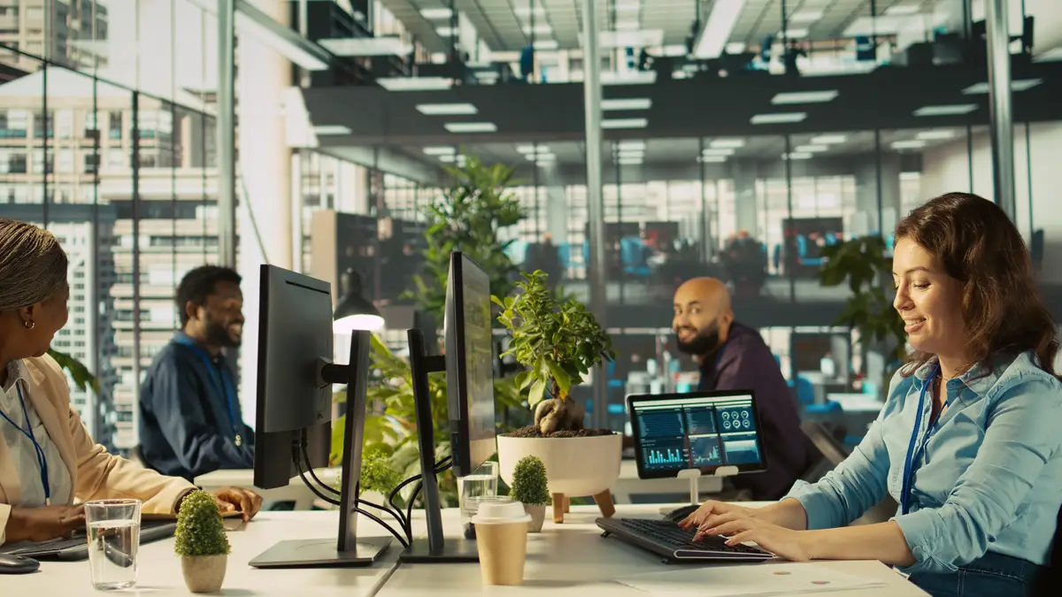 Joyous coworkers having fun in vibrant office while reviewing financial graphs