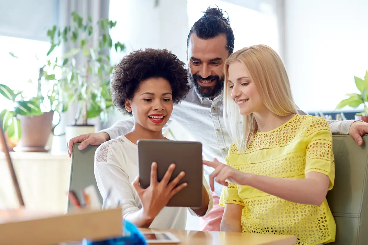 business, technology, startup and people concept - happy creative team with tablet pc computers in office
