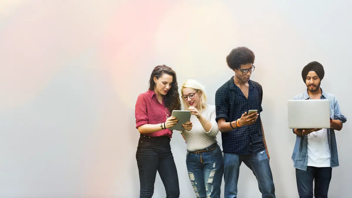 Diverse friends using digital devices