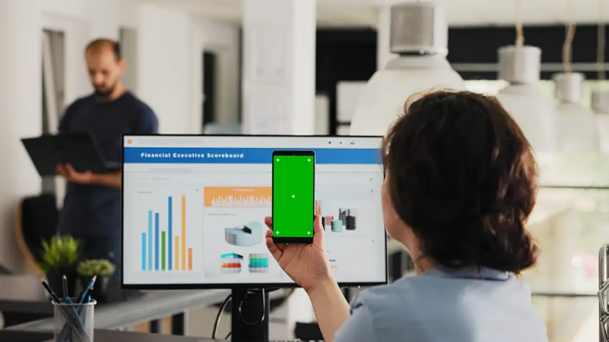 Employee uses phone app with greenscreen