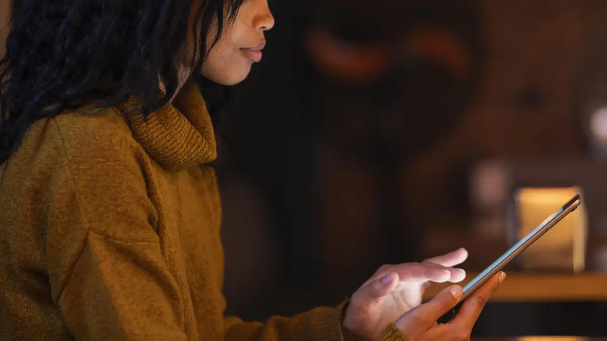 Woman using a tablet in a coffee shop