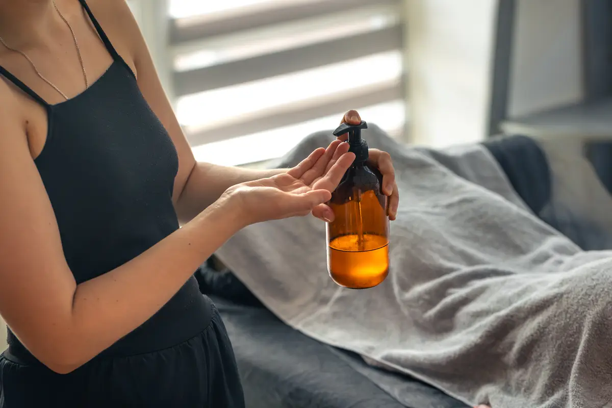 Woman with cosmetic oil bottle modern beauty care product